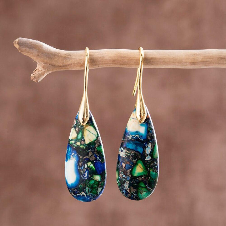 Gold and silver women teardrop stone earrings closeup showcasing handmade gemstone details