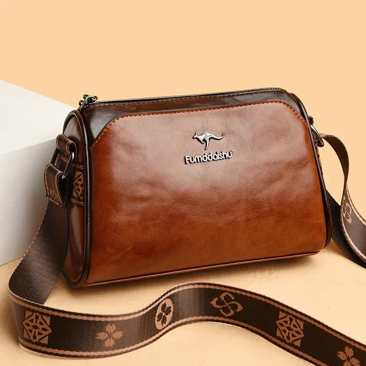 Brown women's crossbody handbag with patterned strap