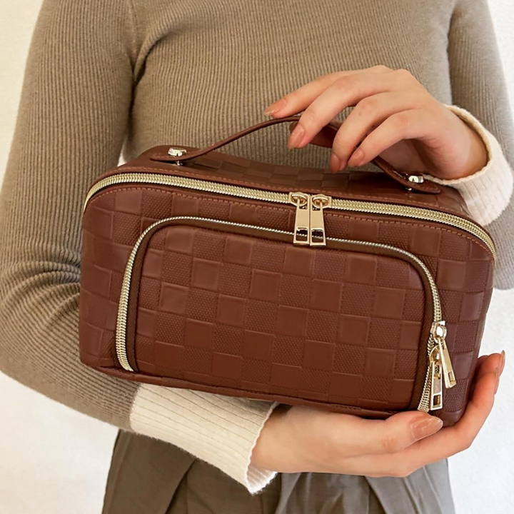 Side profile of the spacious cosmetic travel bag showing durable waterproof fabric