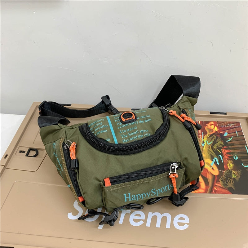 Mens water-resistant waist and sling bag worn across the chest for outdoor travel.