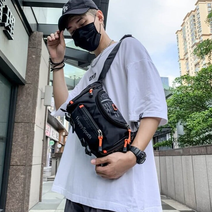 Lifestyle view of male model wearing the water-resistant sling bag downtown.