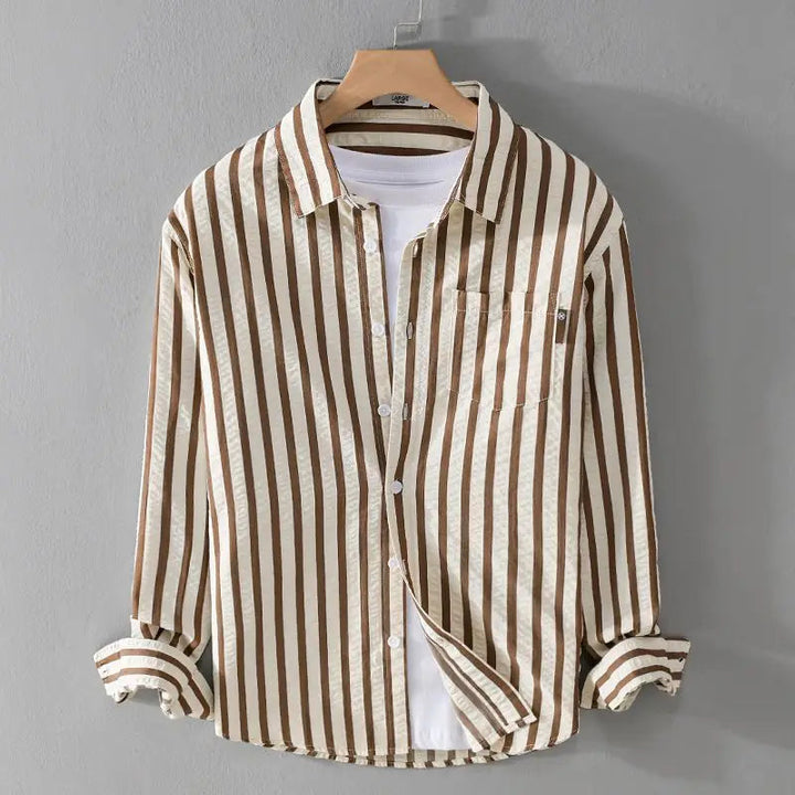 Close-up view of the fabric and button-up closure on a stylish mens long sleeve striped shirt.