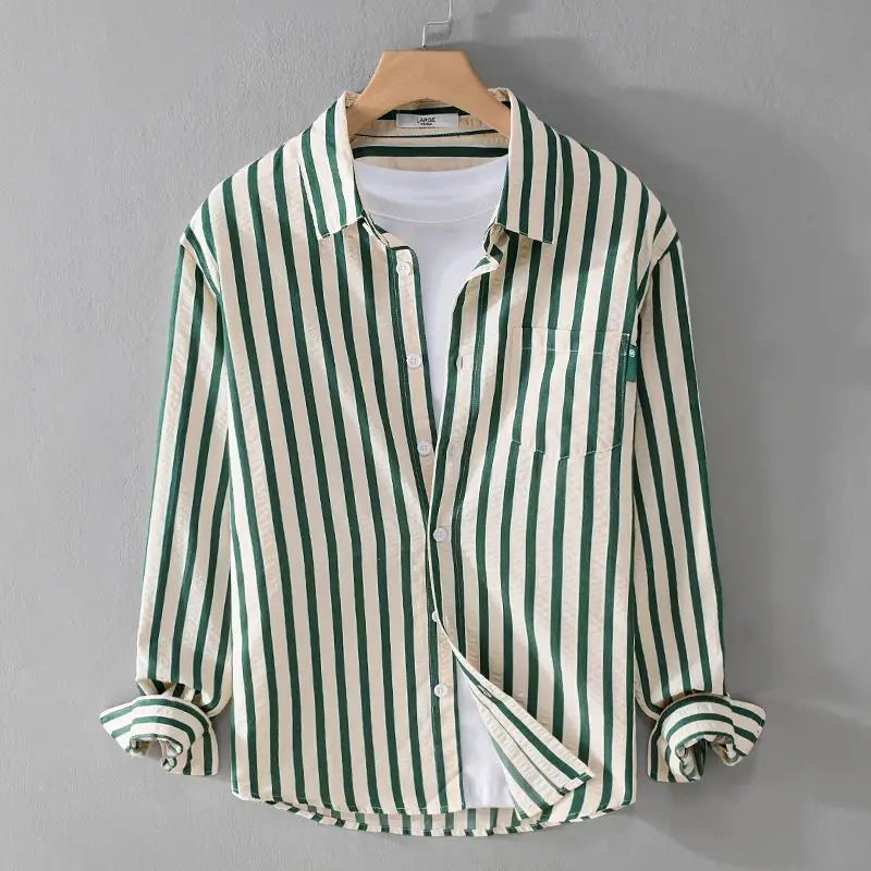 Green and cream striped long sleeve button-up shirt hanging on a hanger