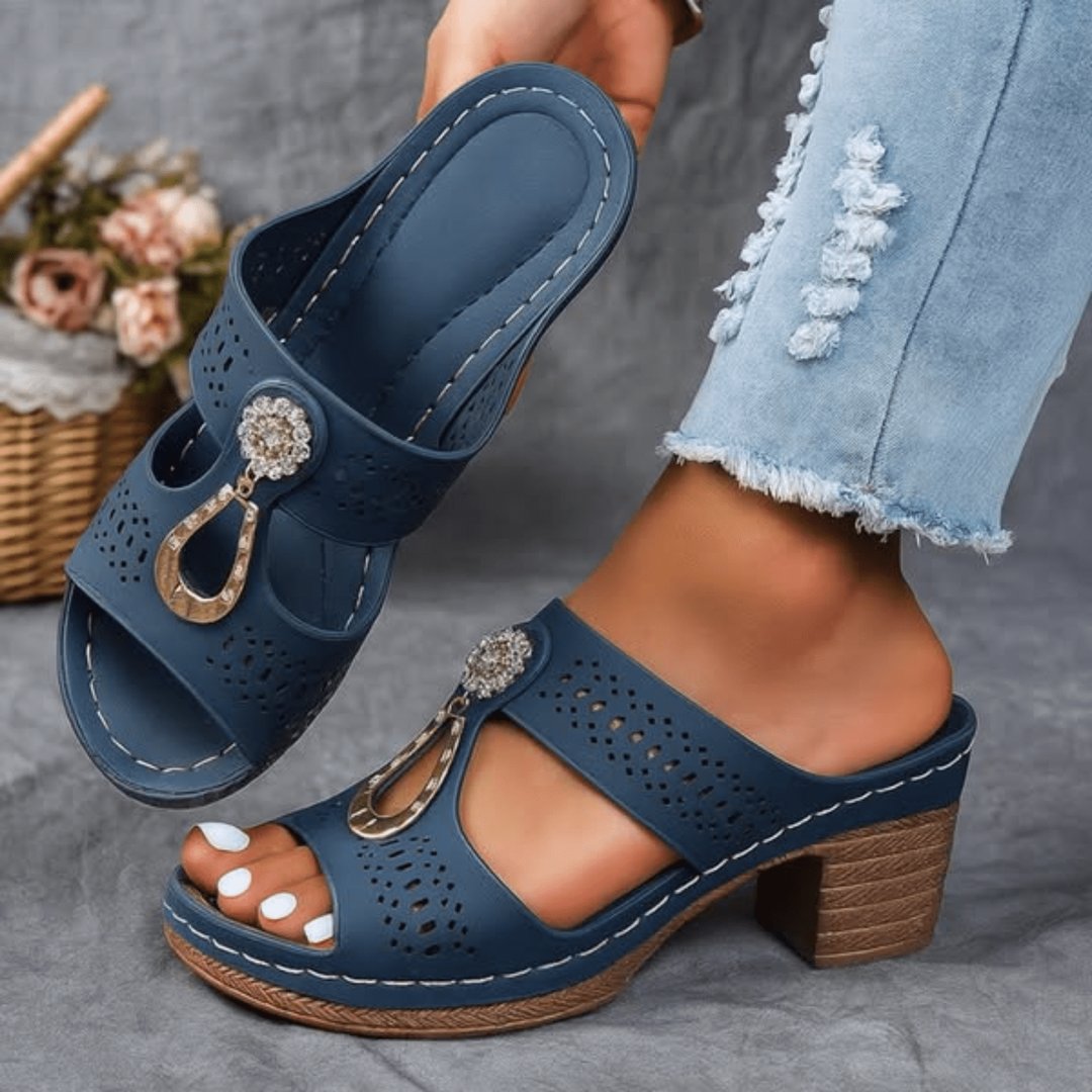 Pair of chic orthopedic sandals for women arranged on a neutral surface