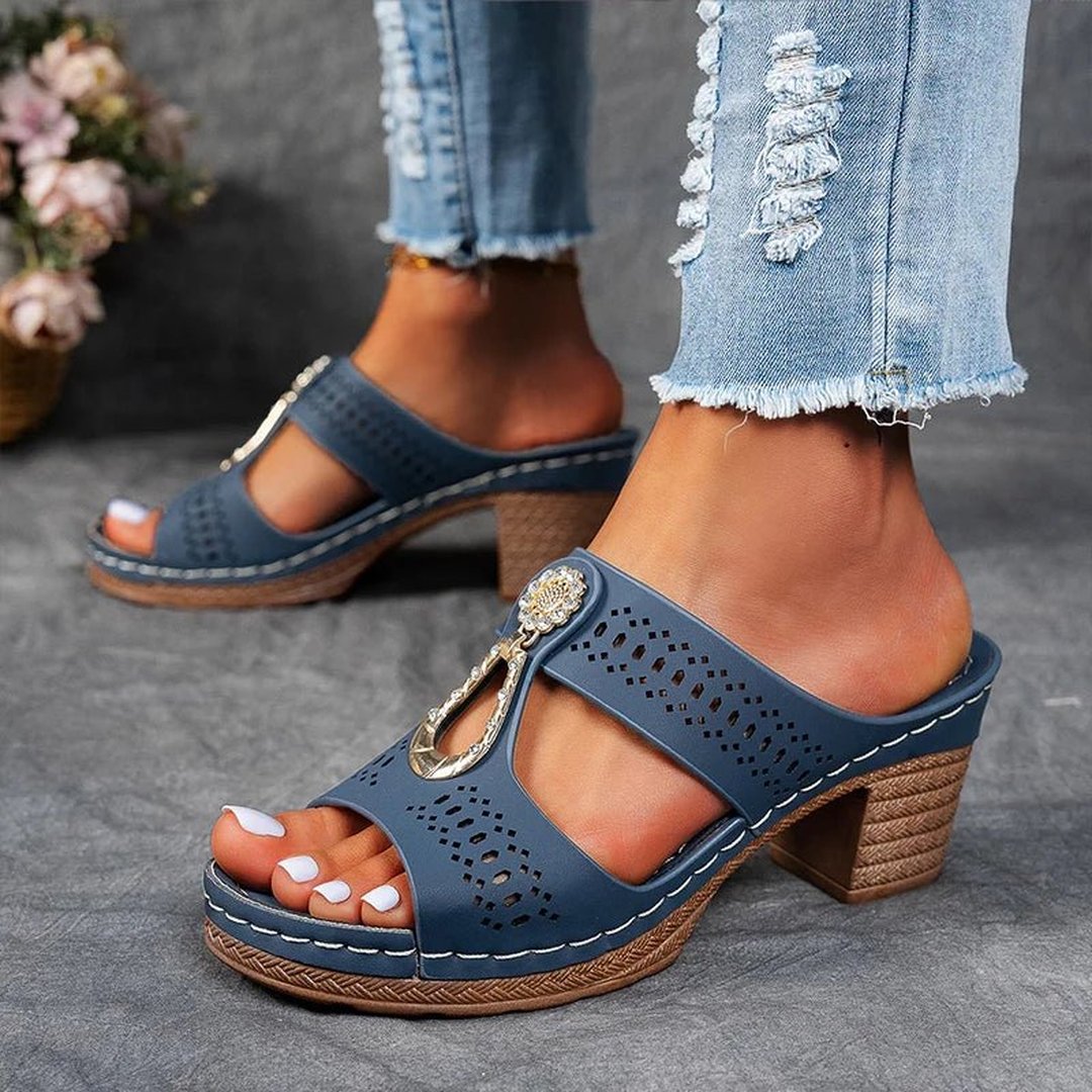 Woman wearing blue orthopedic slide sandals paired with jeans