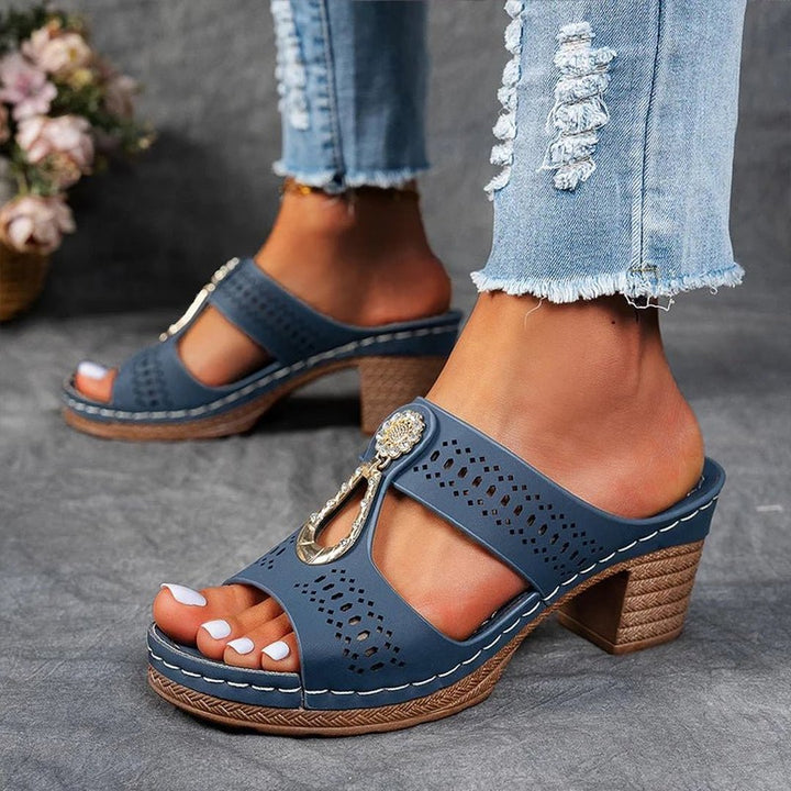 Woman wearing blue orthopedic slide sandals paired with jeans