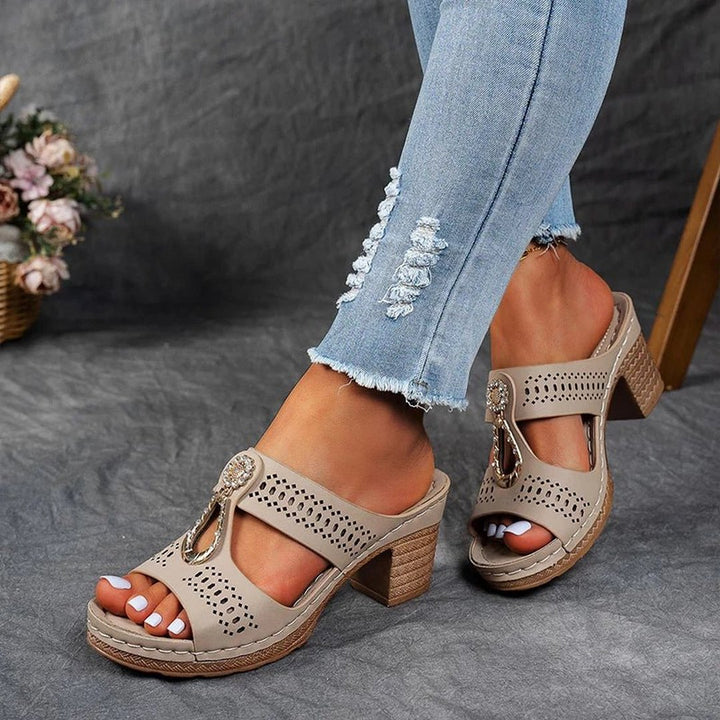 Woman wearing khaki orthopedic slide sandals with block heel
