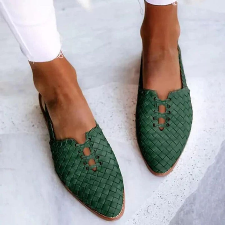 Green woven slip-on sandals shown from a top angle