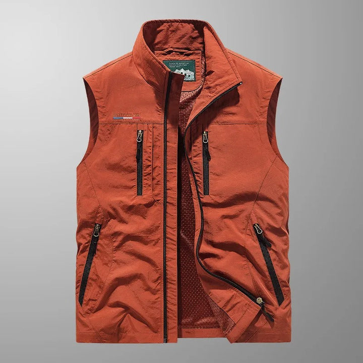 Men's full zip utility vest in orange with multiple pockets and stand collar