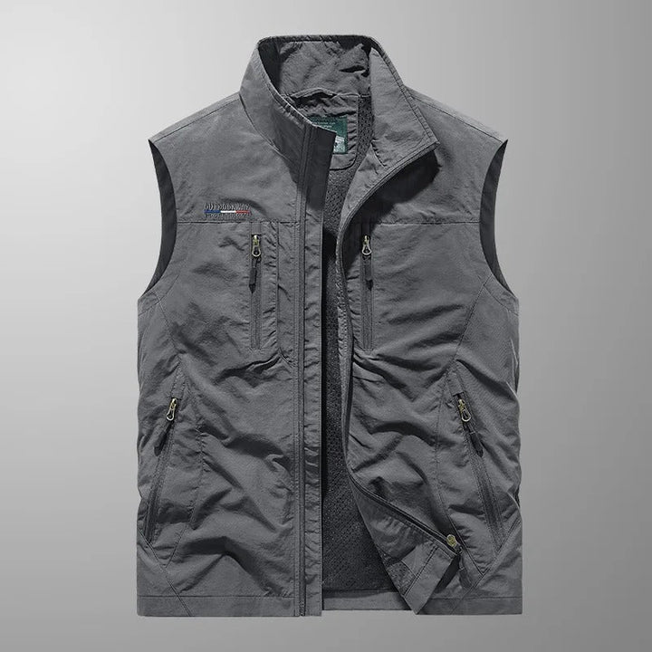 Men's full zip utility vest in gray featuring zippered compartments