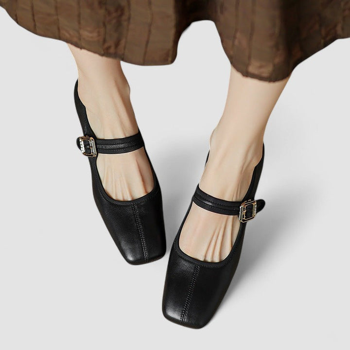 Black orthopedic Mary Jane shoes worn with a skirt