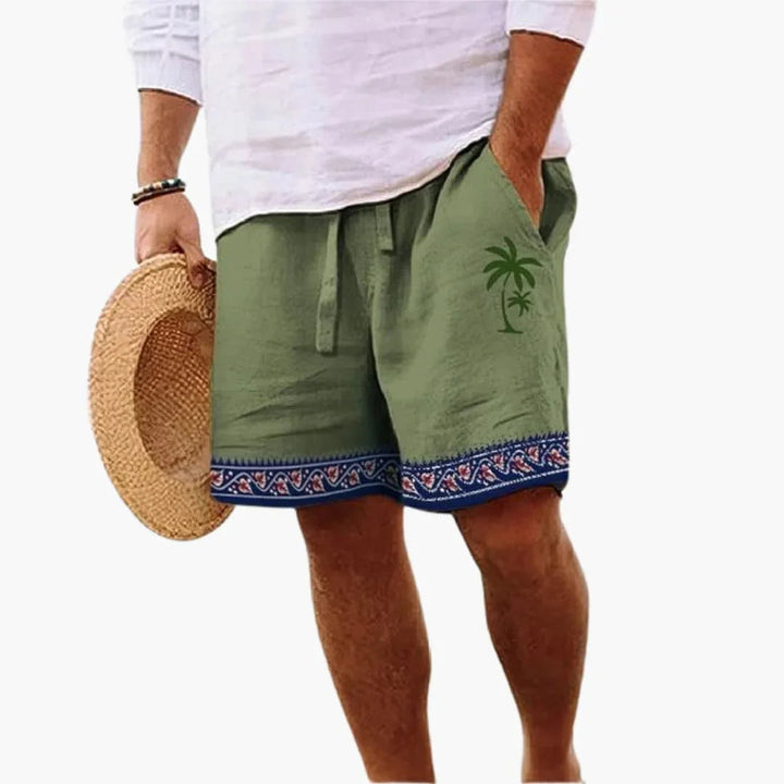 Man wearing green tropical pattern swimming shorts at the beach