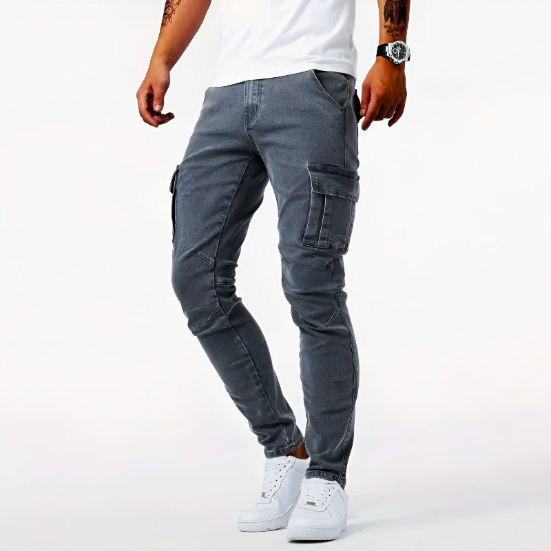 Man wearing grey skinny-fit cargo pants with utility pockets and white sneakers
