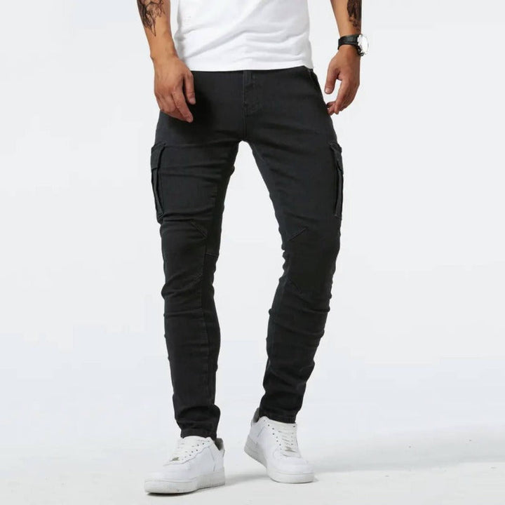 Man wearing black skinny-fit cargo pants with side utility pockets
