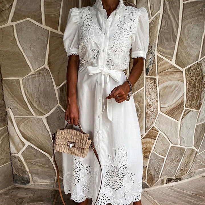 Side profile of elegant white and light blue embroidered beach dress