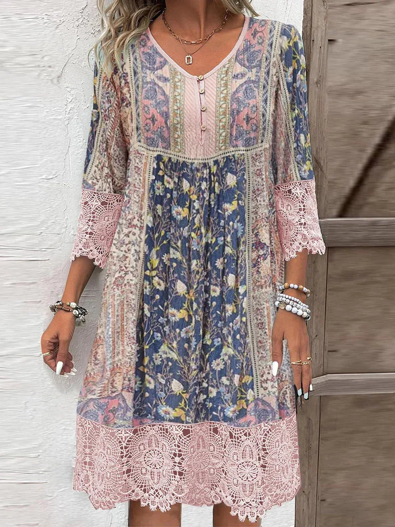 Close-up view of the pink floral midi dress featuring lace trim details