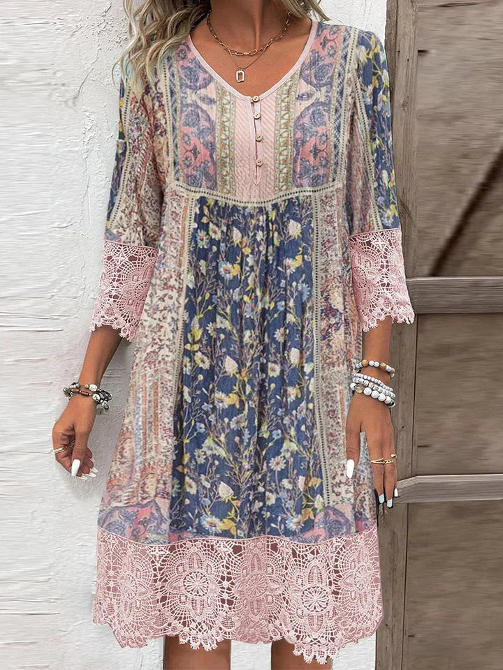 Close-up view of the pink floral midi dress featuring lace trim details