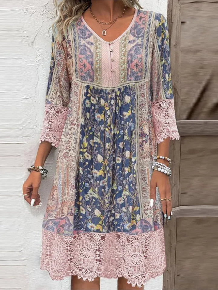 Woman wearing a floral V-neck midi dress in pink with 3/4 sleeves