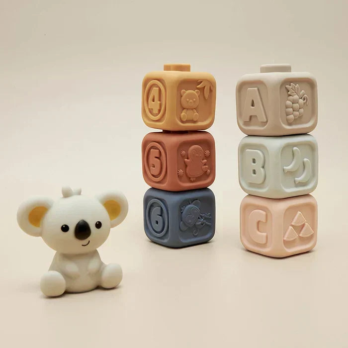 Numbered silicone stacking blocks next to a cute koala companion