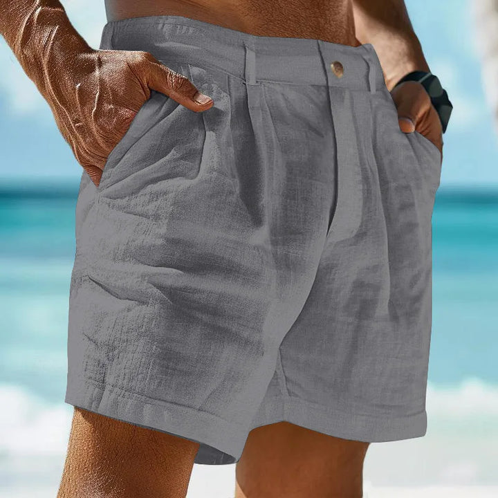 Man wearing grey breathable summer shorts near the ocean