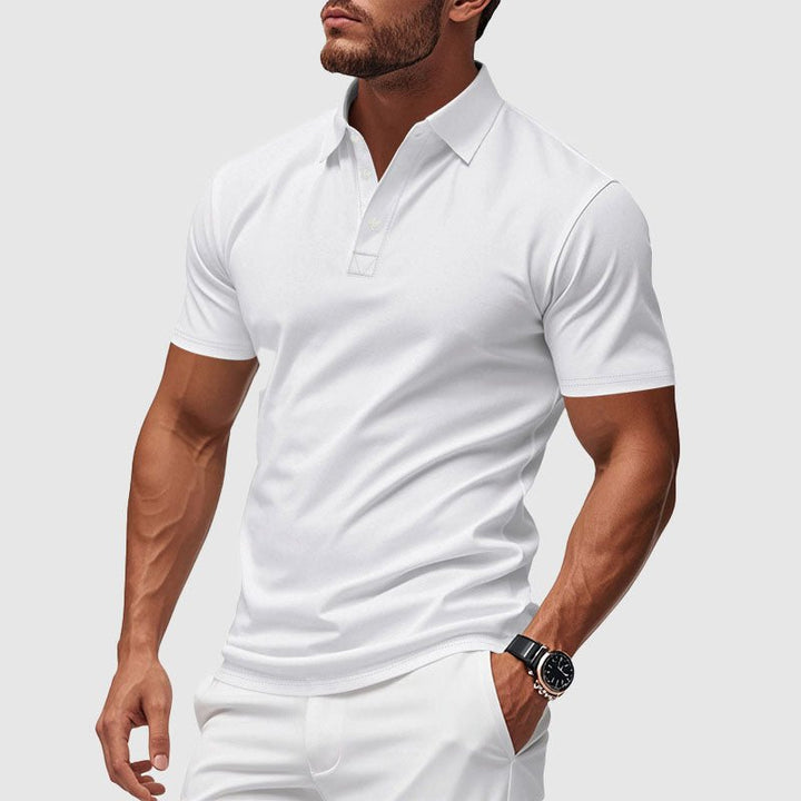 A man wearing a clean white short-sleeve performance polo shirt.