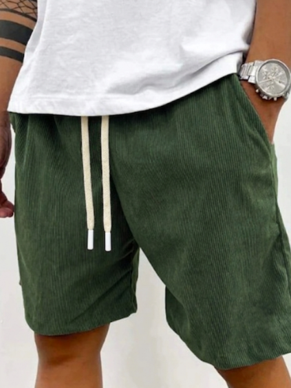 Men's green casual drawstring shorts showing textured fabric