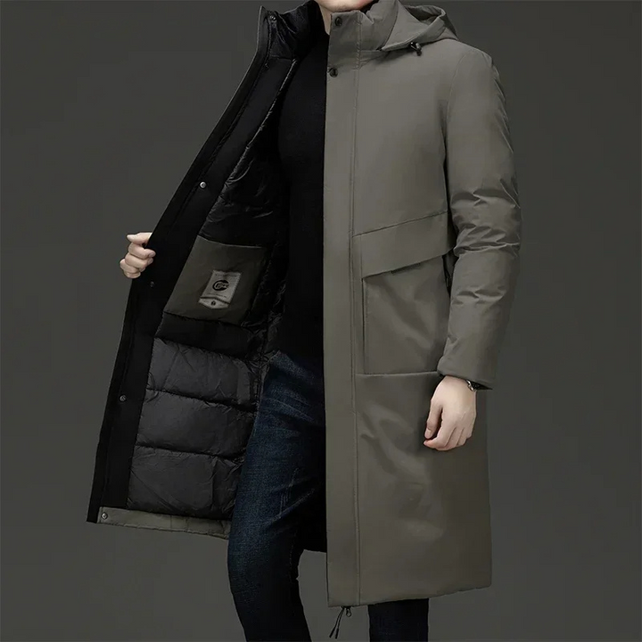 Man wearing grey men's hooded long coat showing padded interior and button closure