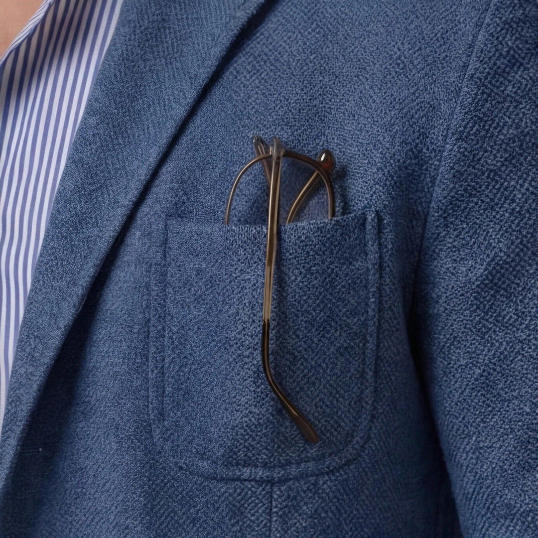 Close-up of pocket detail on a blue men's blazer