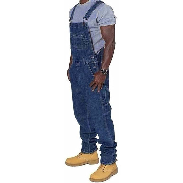 Side profile view of a man wearing durable denim dungarees and utility work boots