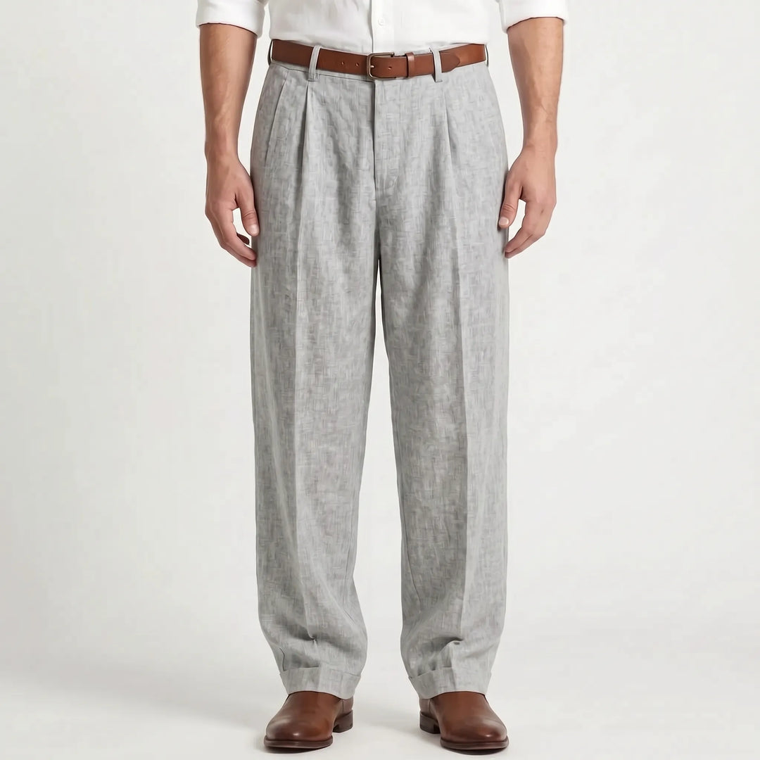 Man wearing gray pleated trousers with a brown belt and leather shoes