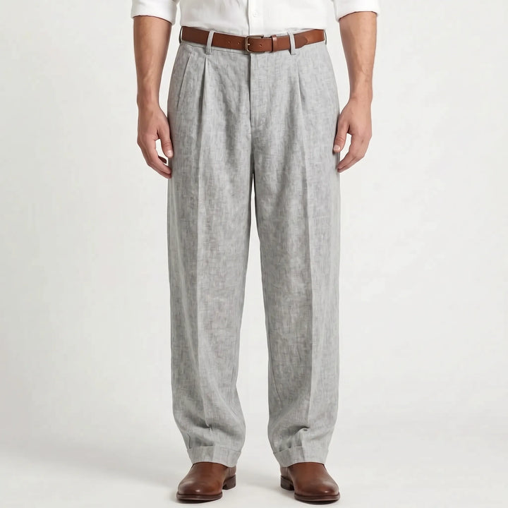 Man wearing gray pleated trousers with a brown belt and leather shoes