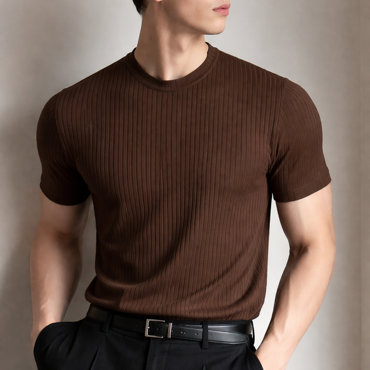 Man wearing a brown ribbed sculpted fit t-shirt paired with black trousers and a belt.