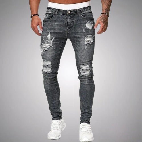 Close up view of mens distressed ripped jeans showcasing trendy denim texture and fashion fit.