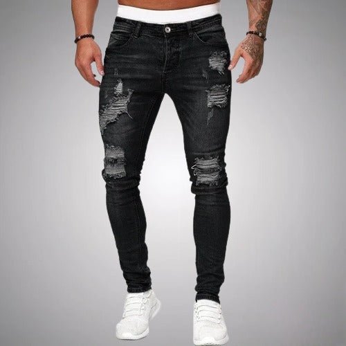 Man wearing black skinny ripped jeans with white sneakers