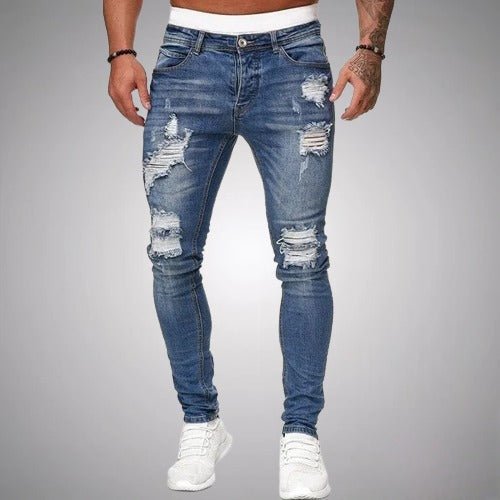 Man wearing blue skinny ripped jeans showcasing streetwear style