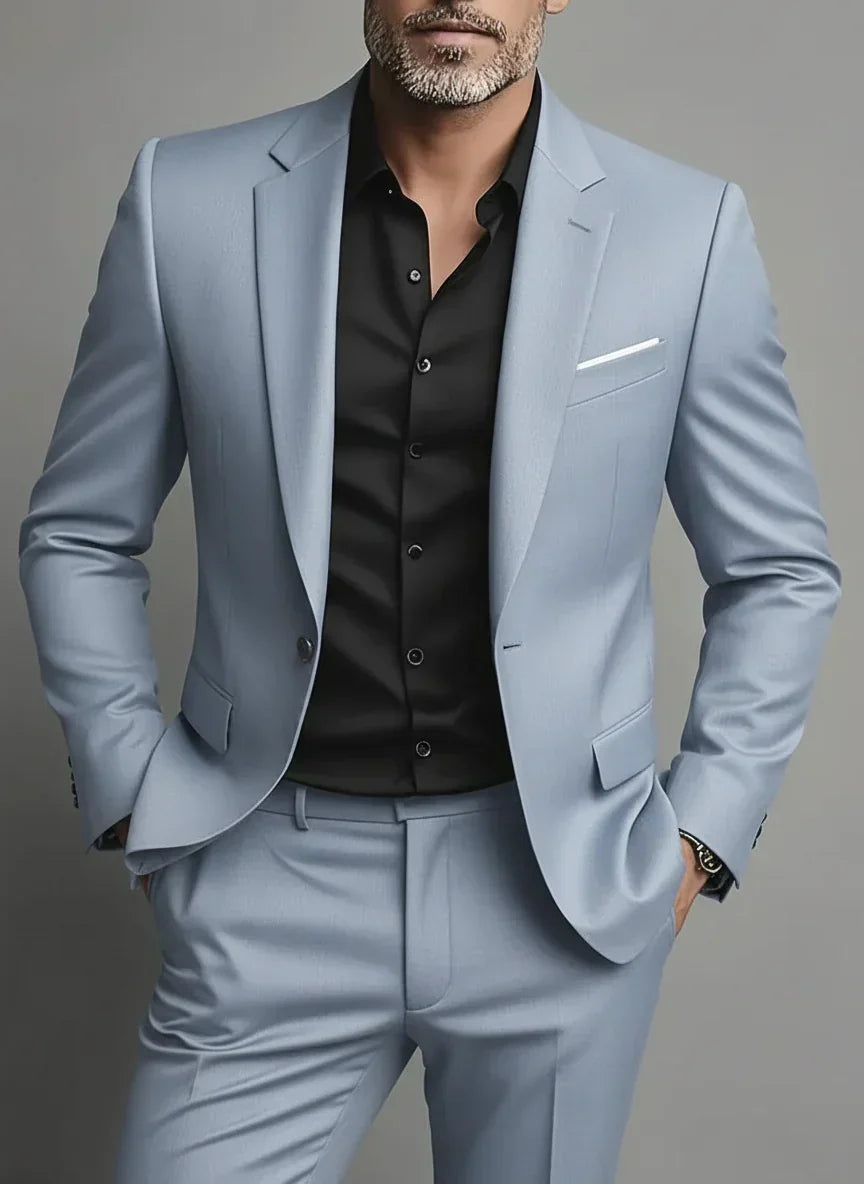 Man wearing a light grey slim fit two-piece suit with a black shirt