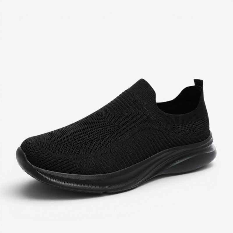 Men's solid black slip-on sneaker viewed from the side