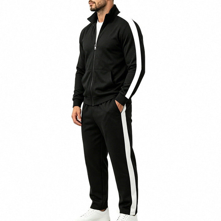 Man wearing a black sports tracksuit set with white contrast stripes and zip-up jacket
