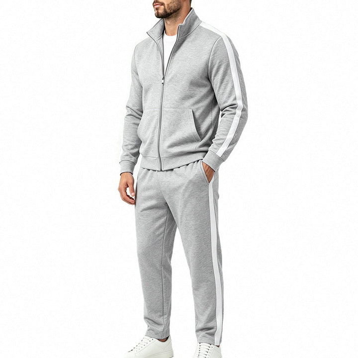Man wearing a light gray sports tracksuit set with contrast striping