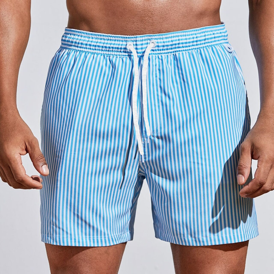 Man wearing light blue striped swim shorts with pockets