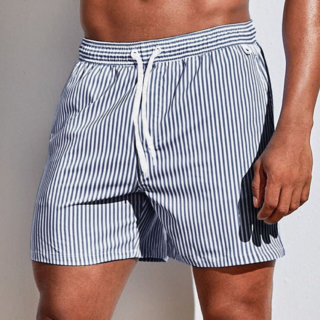Back view of men's striped swim trunks featuring an elastic waistband and drawstring