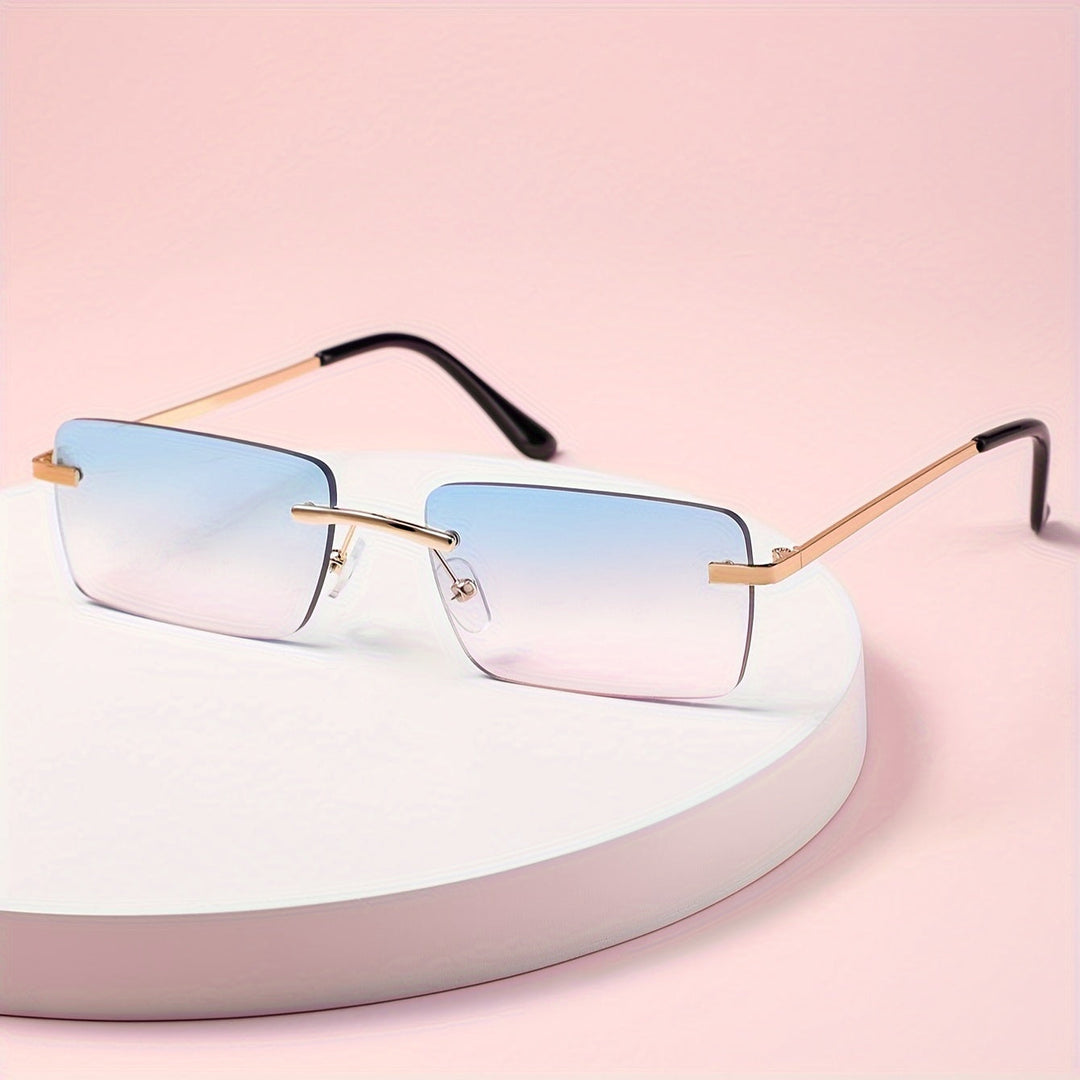 Men's blue and pink gradient frameless sunglasses resting on a white display stand