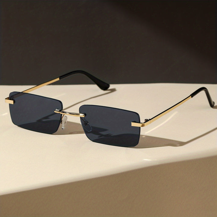 Close-up view of men's fashion eyewear featuring a modern rimless sun protection design