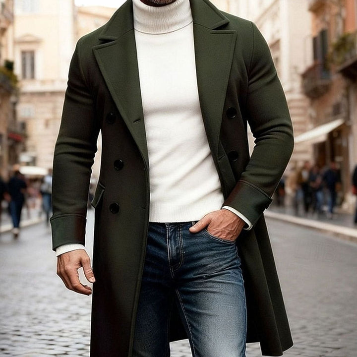 Man wearing an army green long double-breasted overcoat on a city street