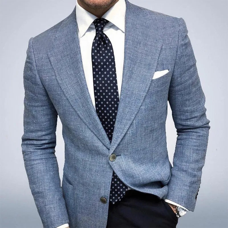 Man wearing Blue textured sport coat with white shirt and patterned tie