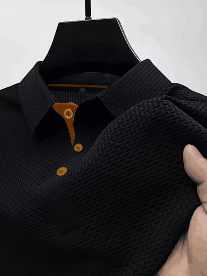 Close-up of black men's textured woven short-sleeve polo shirt hanging on display