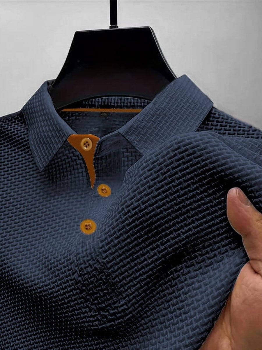 Close-up of dark blue men's textured woven short-sleeve polo shirt fabric pattern