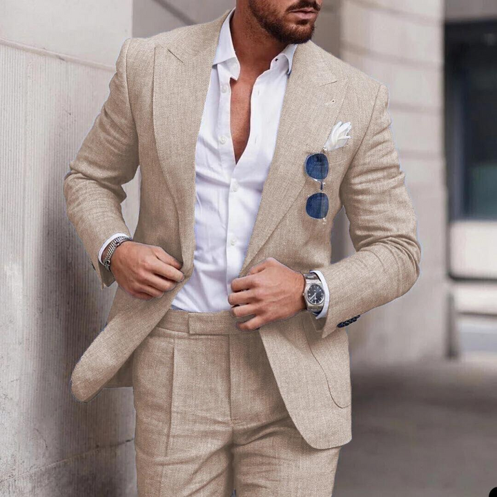 Man wearing a khaki two-piece suit with a white button-down shirt and pocket square