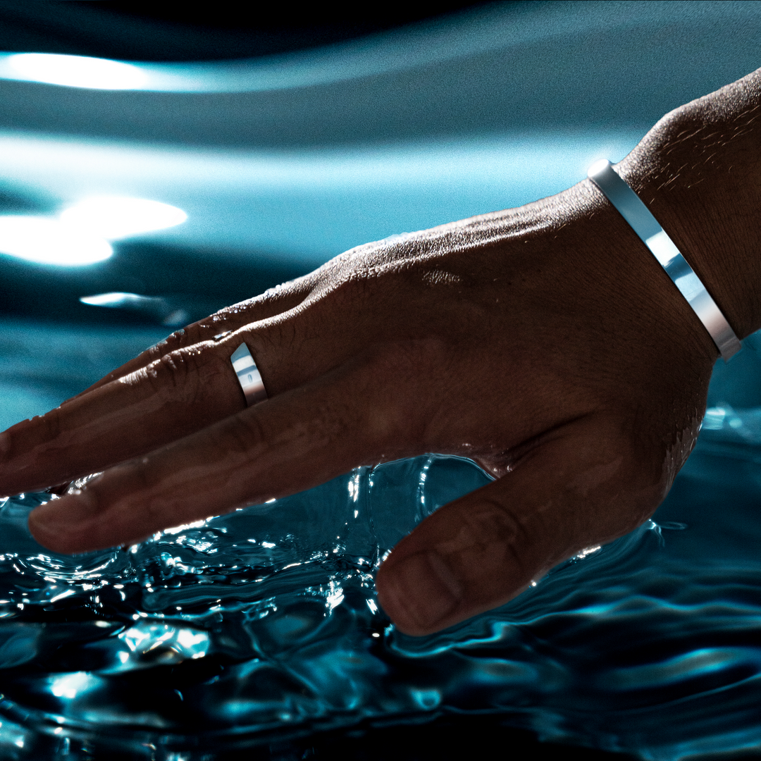 Close-up of the silver and gold finish on the Arvid men's open band ring accessory