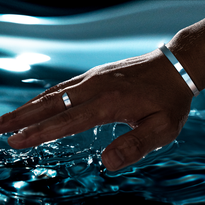 Close-up of the silver and gold finish on the Arvid men's open band ring accessory